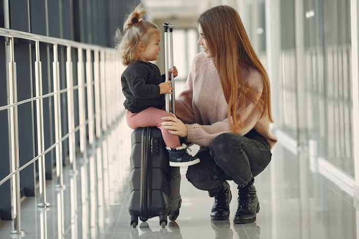 Woman and her little daughter at the airport
