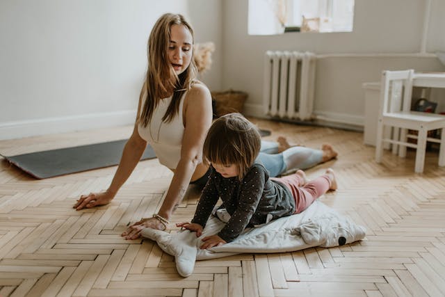 Mother and daughter exercise on the floor.